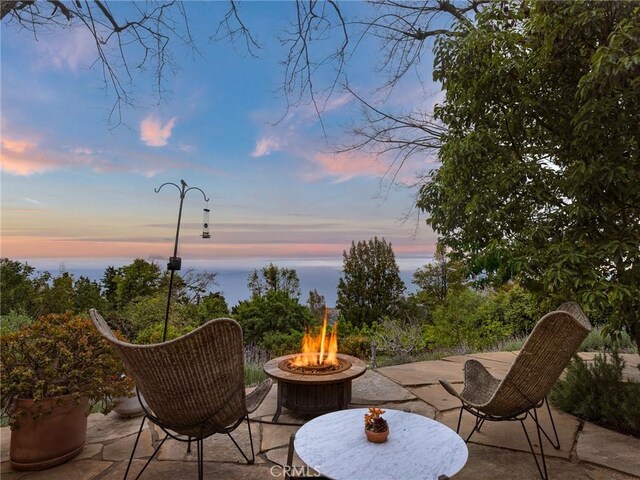 7 Cinchring Rd, Rolling Hills, CA 90274 - patio terrace at dusk with an outdoor fire pit and a patio