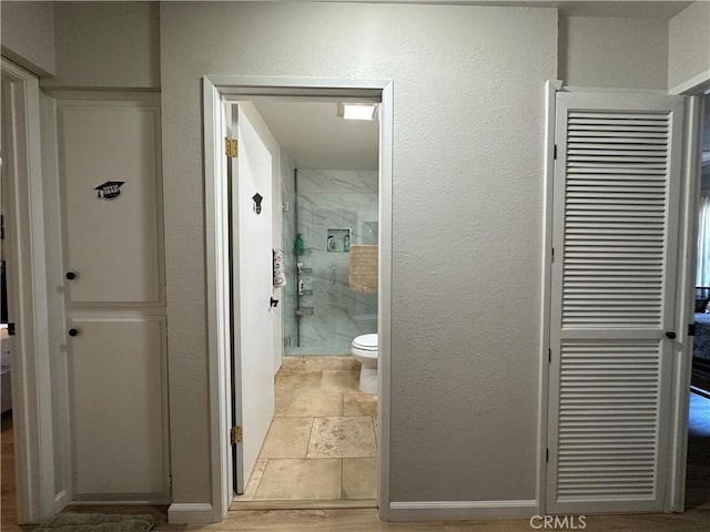 680 Chorro St Unit 18, San Luis Obispo, CA 93401 - full bath featuring stone tile floors, a shower stall, toilet, and baseboards