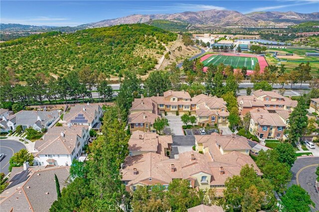 614 Timberwood, Irvine, CA 92620 - aerial overview of property's location with a mountain backdrop and nearby suburban area