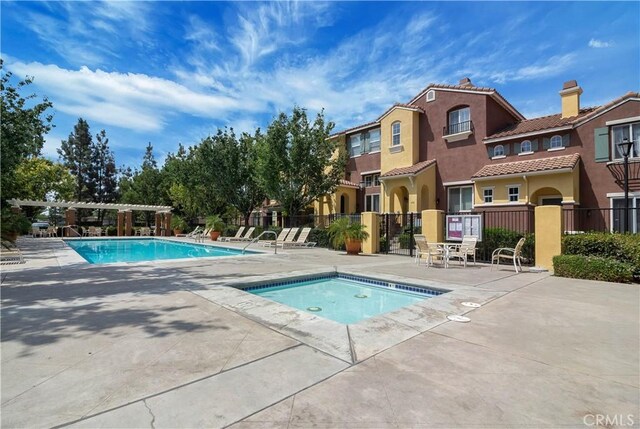 614 Timberwood, Irvine, CA 92620 - community pool featuring a community hot tub, a pergola, a patio area, and a residential view