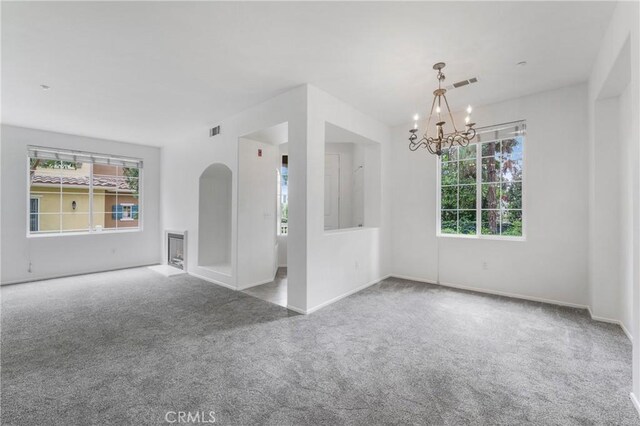 614 Timberwood, Irvine, CA 92620 - spare room with carpet, a chandelier, and plenty of natural light