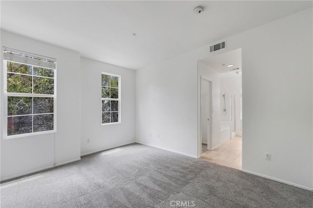 614 Timberwood, Irvine, CA 92620 - unfurnished room with light carpet, baseboards, a smoke detector, and light tile patterned floors