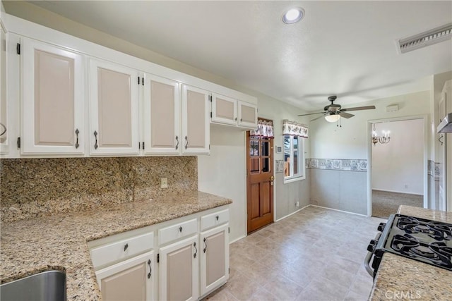 436 W Porter Ave, Fullerton, CA 92832 - kitchen featuring range with gas stovetop, ceiling fan, white cabinets, a wainscoted wall, and light stone countertops