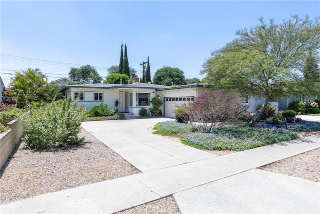 436 W Porter Ave, Fullerton, CA 92832 - single story home featuring an attached garage, driveway, stucco siding, and a chimney