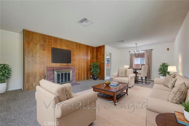 436 W Porter Ave, Fullerton, CA 92832 - living area featuring a chandelier, wooden walls, and a fireplace