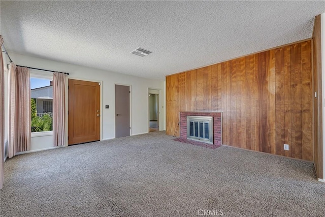 436 W Porter Ave, Fullerton, CA 92832 - unfurnished living room with carpet flooring, wood walls, a textured ceiling, and a fireplace
