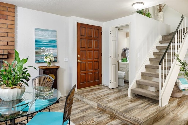 34101 Via California Unit 12, San Juan Capistrano, CA 92675 - foyer entrance with light wood-style floors and stairway