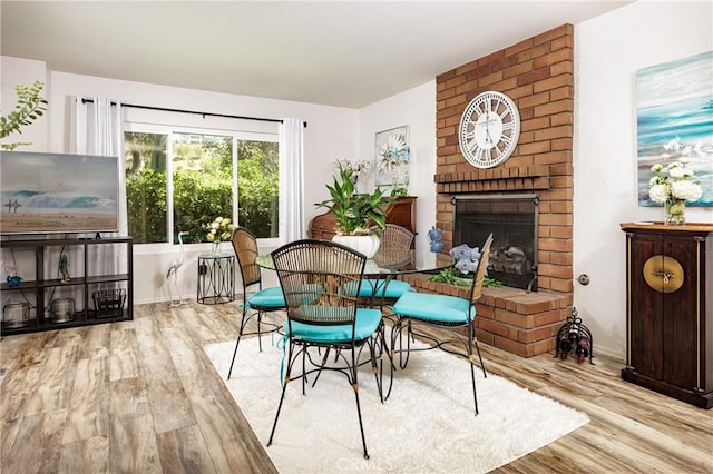 34101 Via California Unit 12, San Juan Capistrano, CA 92675 - dining room with wood finished floors and a fireplace