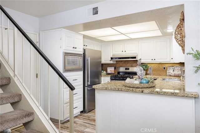 34101 Via California Unit 12, San Juan Capistrano, CA 92675 - kitchen featuring appliances with stainless steel finishes, a sink, under cabinet range hood, and white cabinetry