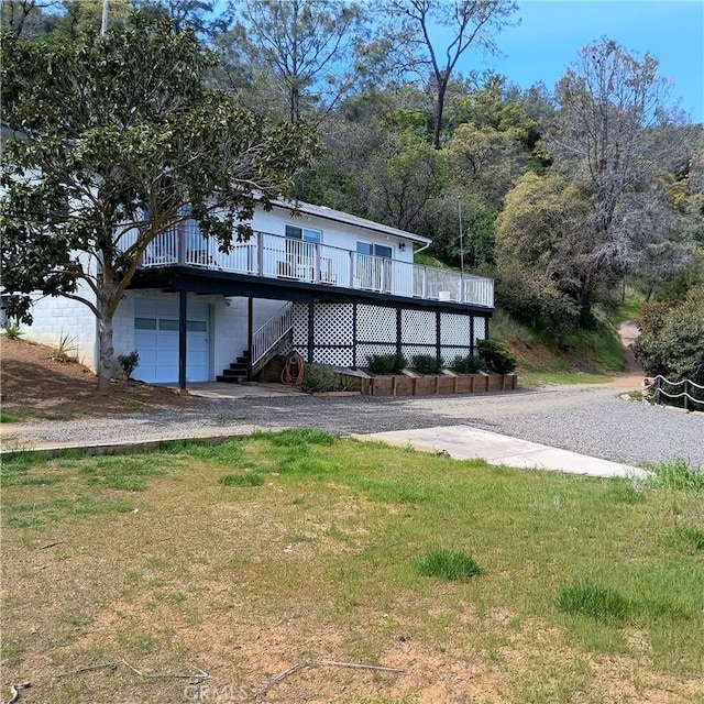 10098 Crestview Dr, Clearlake, CA 95424 - view of front of home featuring a wooden deck, stairs, a garage, and a front lawn