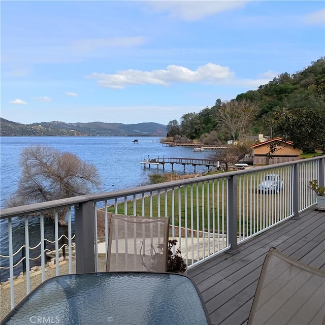 10098 Crestview Dr, Clearlake, CA 95424 - wooden terrace featuring a water and mountain view, outdoor dining space, and a boat dock