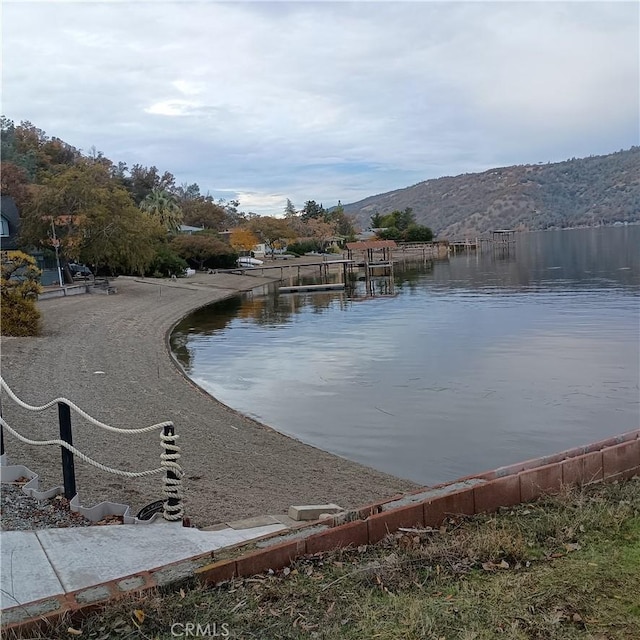 10098 Crestview Dr, Clearlake, CA 95424 - water view featuring a mountain backdrop and a boat dock