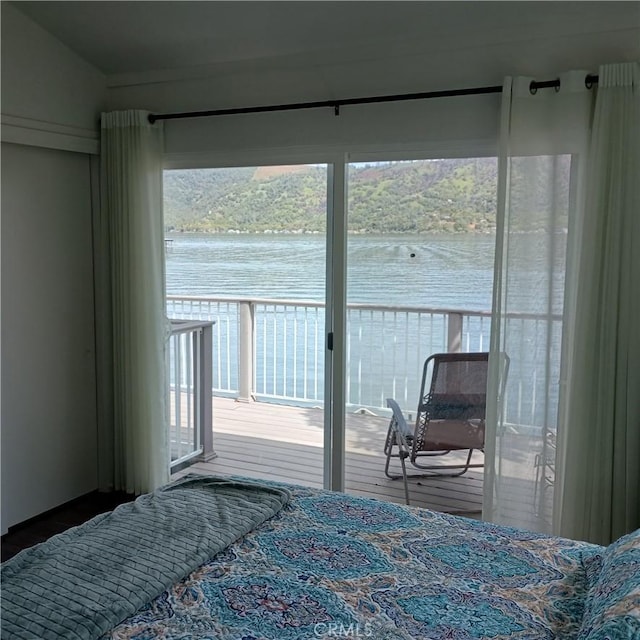 10098 Crestview Dr, Clearlake, CA 95424 - bedroom featuring access to outside, multiple windows, a water view, and wood finished floors