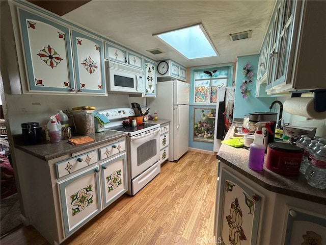 161 Janet Ave, Grover Beach, CA 93433 - kitchen featuring white appliances, a skylight, light wood finished floors, and dark countertops