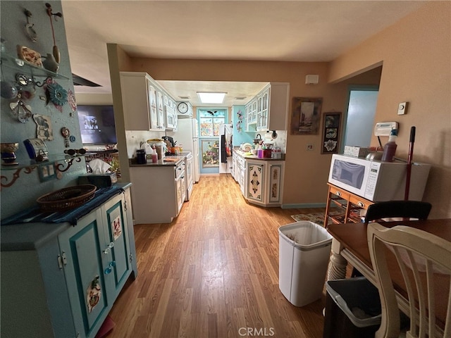 161 Janet Ave, Grover Beach, CA 93433 - kitchen featuring white microwave, dark countertops, and light wood finished floors