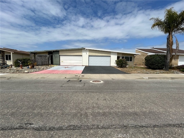 161 Janet Ave, Grover Beach, CA 93433 - mid-century modern home featuring a garage, driveway, and stucco siding
