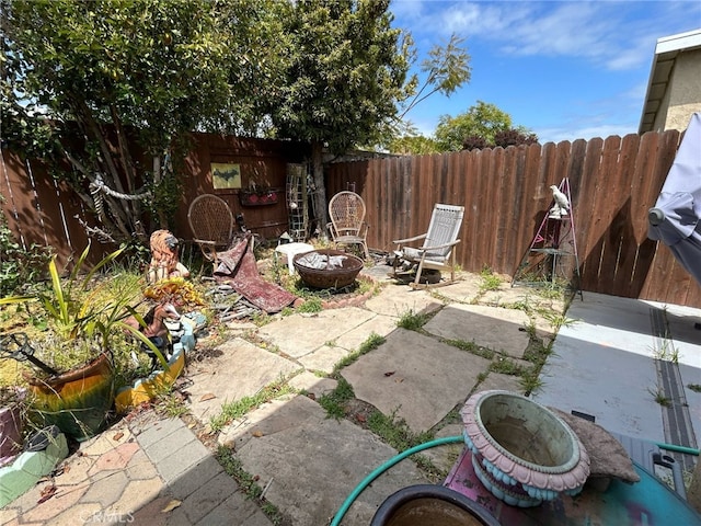161 Janet Ave, Grover Beach, CA 93433 - fenced backyard with an outdoor fire pit and a patio