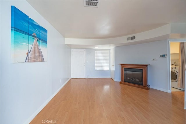 13905 Magnolia St, Garden Grove, CA 92844 - unfurnished living room featuring washer / clothes dryer, wood finished floors, and a glass covered fireplace