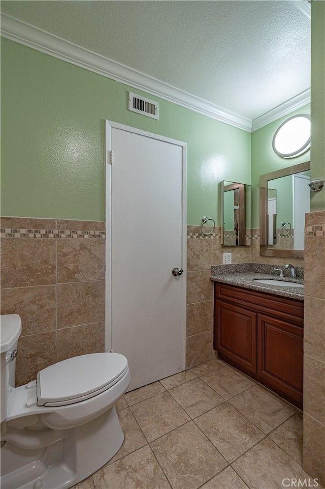 13905 Magnolia St, Garden Grove, CA 92844 - bathroom featuring tile walls, ornamental molding, tile patterned flooring, vanity, and wainscoting