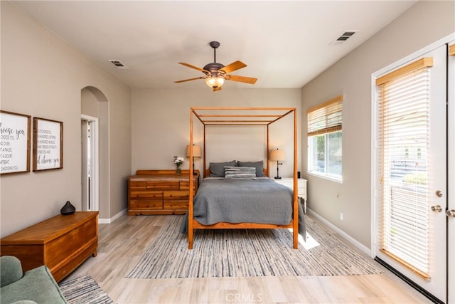23840 Costa Mesa Way, Murrieta, CA 92562 - bedroom featuring arched walkways, wood finished floors, baseboards, access to exterior, and a ceiling fan