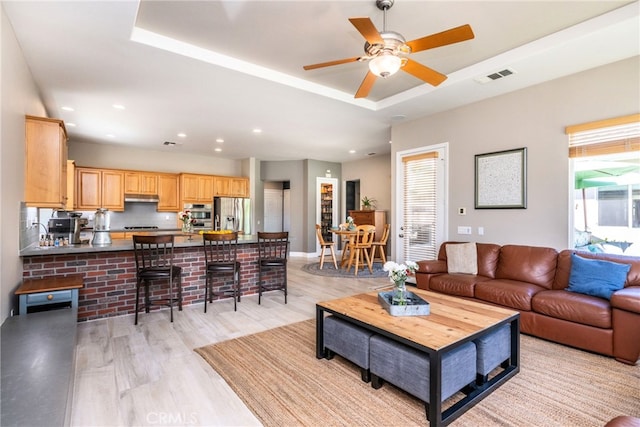 23840 Costa Mesa Way, Murrieta, CA 92562 - living area featuring light wood finished floors, a raised ceiling, a ceiling fan, recessed lighting, and baseboards