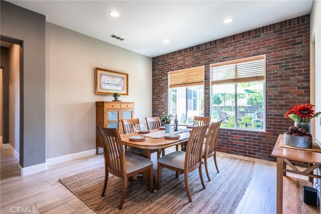 23840 Costa Mesa Way, Murrieta, CA 92562 - dining area with light wood-style floors, baseboards, brick wall, and recessed lighting