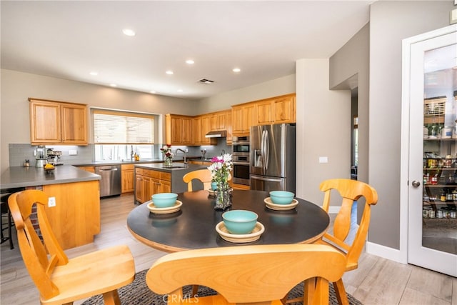 23840 Costa Mesa Way, Murrieta, CA 92562 - kitchen featuring stainless steel appliances, a center island with sink, light wood-type flooring, a sink, and recessed lighting
