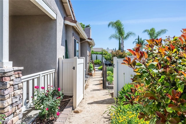 23840 Costa Mesa Way, Murrieta, CA 92562 - view of side of home featuring a gate, stucco siding, and a chimney