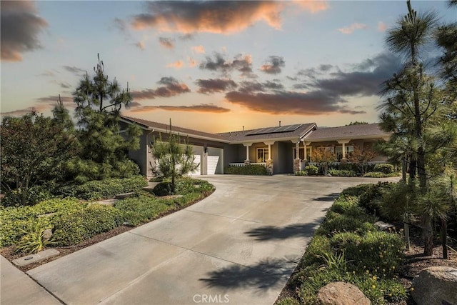 23840 Costa Mesa Way, Murrieta, CA 92562 - view of front of home featuring an attached garage, solar panels, concrete driveway, and stucco siding