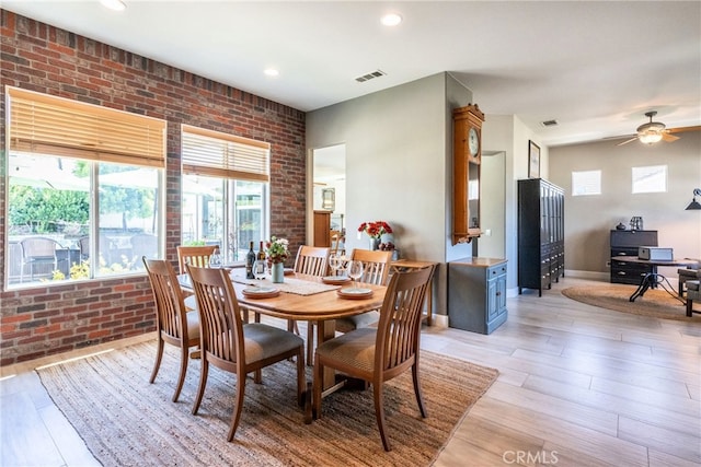 23840 Costa Mesa Way, Murrieta, CA 92562 - dining space with brick wall, healthy amount of natural light, light wood-type flooring, a ceiling fan, and a desk