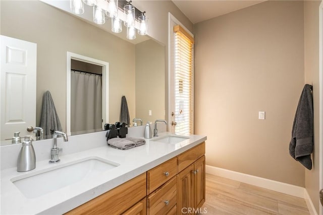 23840 Costa Mesa Way, Murrieta, CA 92562 - full bathroom with double vanity, wood finished floors, and baseboards