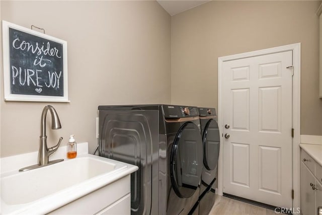 23840 Costa Mesa Way, Murrieta, CA 92562 - laundry room with washing machine and clothes dryer, cabinet space, and light wood-type flooring