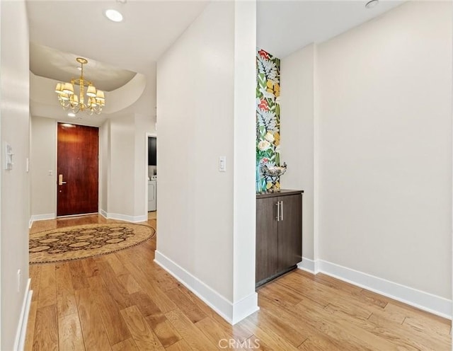 402 Rockefeller Unit 407, Irvine, CA 92612 - corridor featuring light wood-style floors, a chandelier, baseboards, and recessed lighting