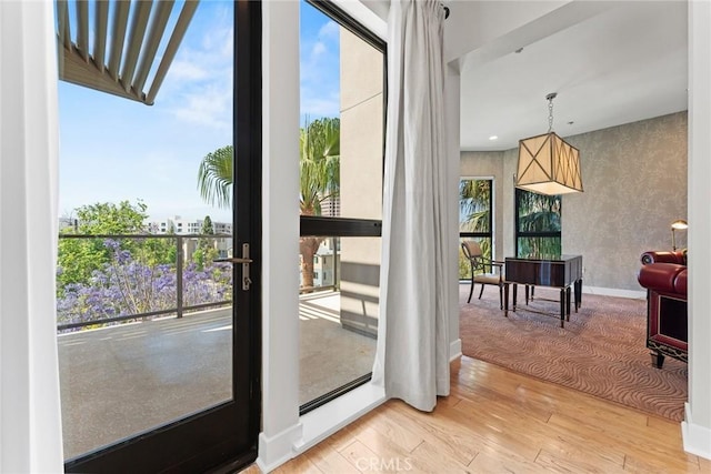 402 Rockefeller Unit 407, Irvine, CA 92612 - doorway to outside featuring light wood finished floors, wallpapered walls, and baseboards