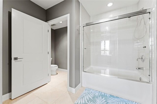 402 Rockefeller Unit 407, Irvine, CA 92612 - bathroom with toilet, baseboards, shower / bath combination with glass door, recessed lighting, and tile patterned flooring