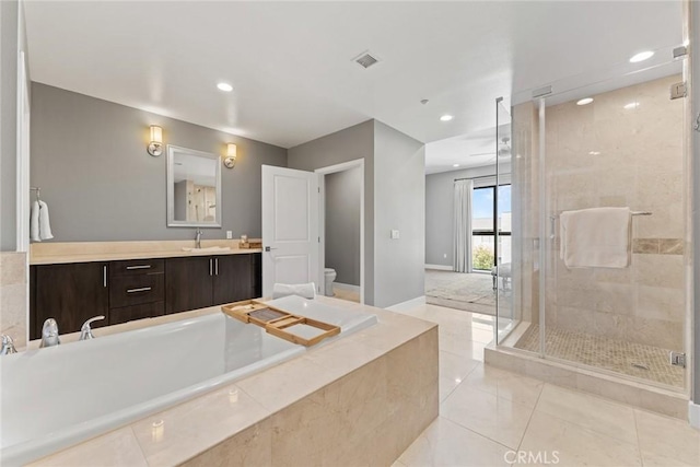402 Rockefeller Unit 407, Irvine, CA 92612 - full bath with toilet, vanity, a bath, a shower stall, and baseboards
