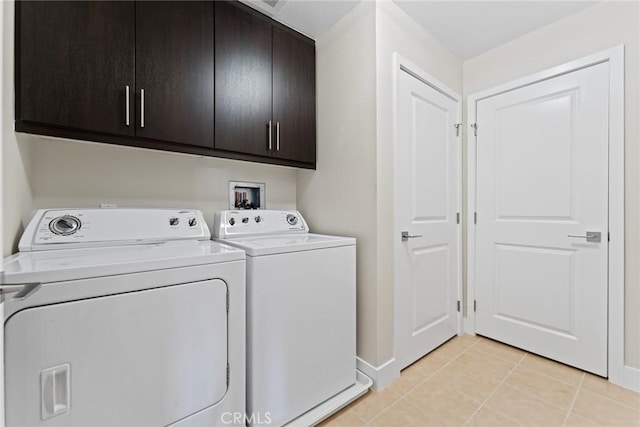 402 Rockefeller Unit 407, Irvine, CA 92612 - laundry area featuring cabinet space, washing machine and clothes dryer, baseboards, and light tile patterned flooring