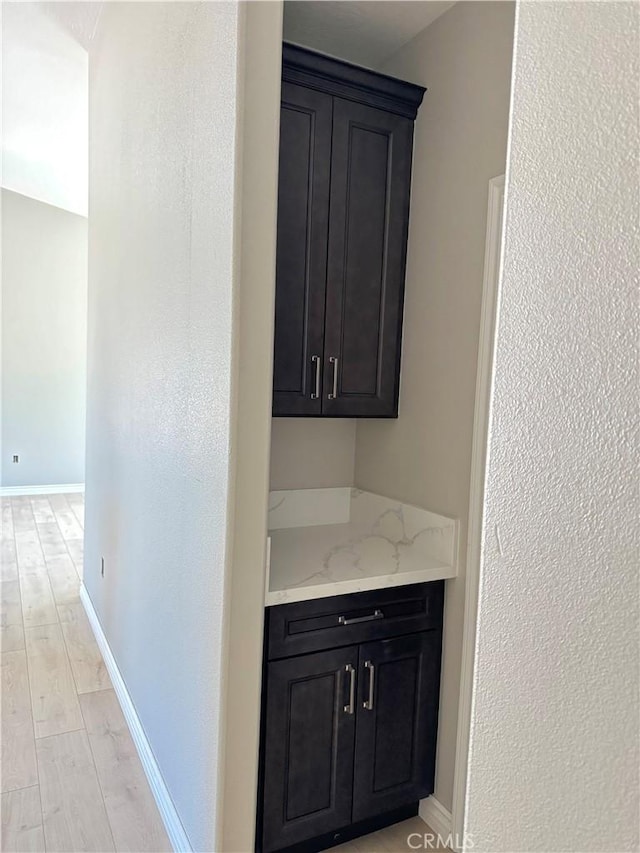 16063 Spruce St, Hesperia, CA 92345 - bar area with light wood-style floors, baseboards, and a textured wall