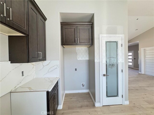 16063 Spruce St, Hesperia, CA 92345 - kitchen featuring dark brown cabinets, light wood finished floors, and decorative backsplash