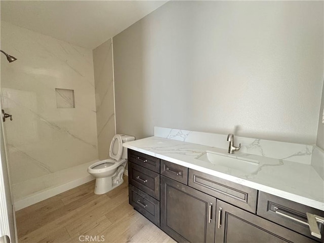 16063 Spruce St, Hesperia, CA 92345 - bathroom featuring vanity, a stall shower, wood finished floors, and toilet