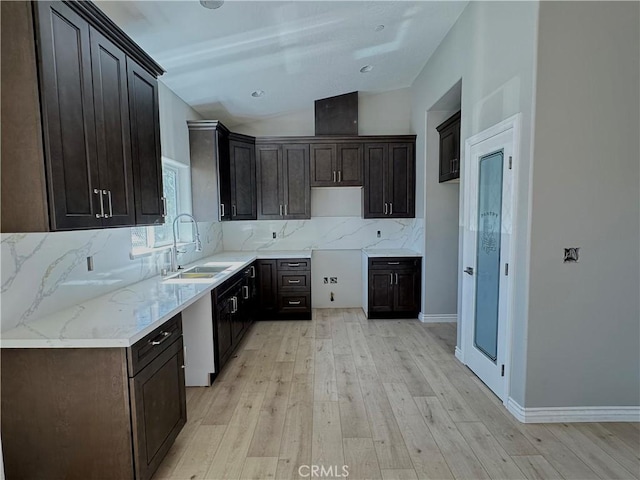 16063 Spruce St, Hesperia, CA 92345 - kitchen with a sink, light wood-style flooring, decorative backsplash, lofted ceiling, and dark brown cabinetry
