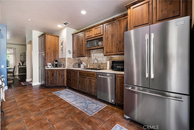 11576 Meridian Rd, Chico, CA 95973 - kitchen featuring stainless steel appliances, a sink, light countertops, tasteful backsplash, and dark tile patterned floors