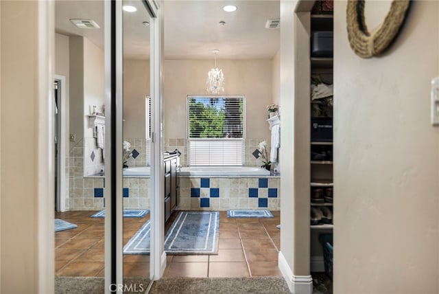 11576 Meridian Rd, Chico, CA 95973 - bathroom featuring a garden tub, tile patterned flooring, a chandelier, recessed lighting, and a spacious closet