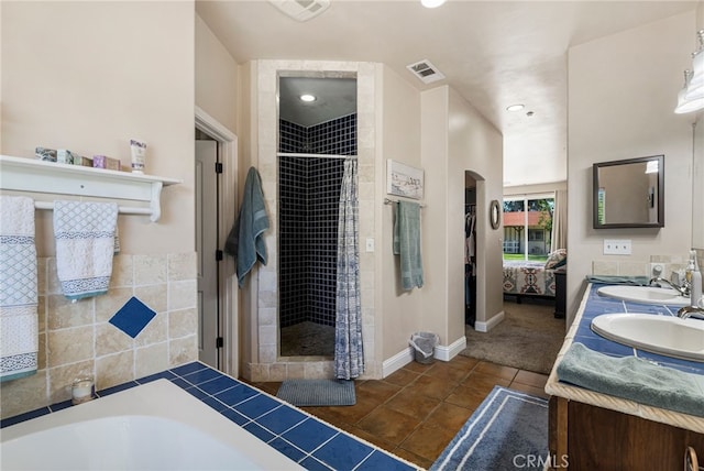 11576 Meridian Rd, Chico, CA 95973 - ensuite bathroom featuring double vanity, a stall shower, a garden tub, baseboards, and tile patterned floors