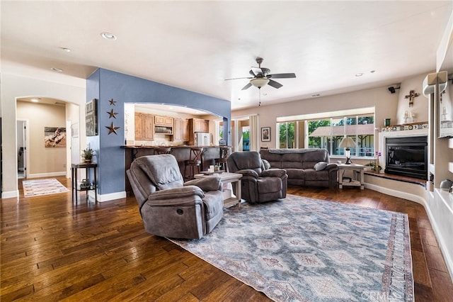 11576 Meridian Rd, Chico, CA 95973 - living room with arched walkways, a ceiling fan, dark wood-type flooring, a glass covered fireplace, and recessed lighting