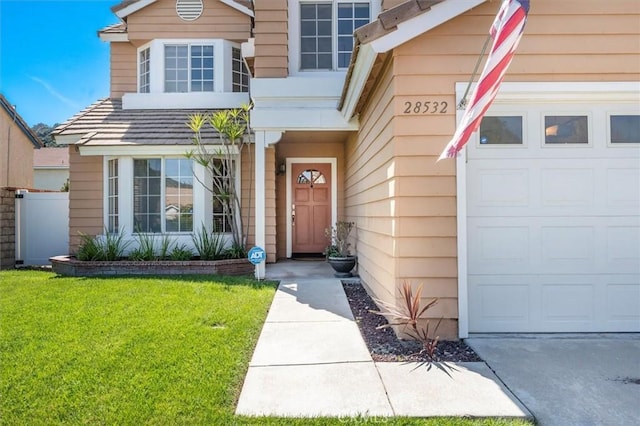 28532 Forest Meadow Pl, Castaic, CA 91384 - view of exterior entry featuring an attached garage, a lawn, and driveway