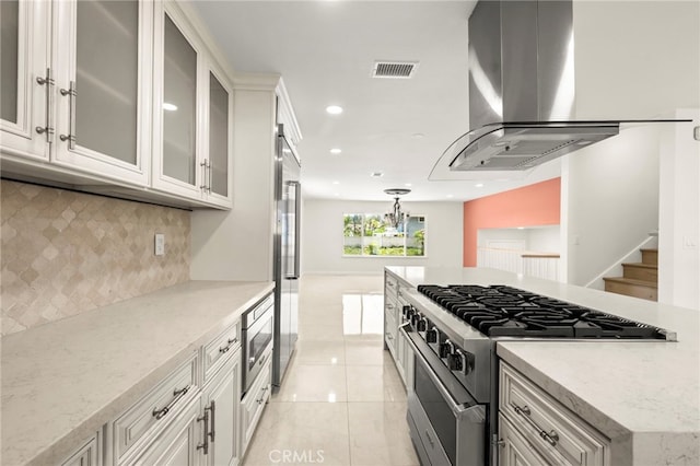 241 S Solomon Dr, Anaheim, CA 92807 - kitchen featuring high end appliances, wall chimney range hood, decorative backsplash, light tile patterned floors, and light stone countertops