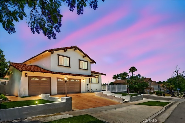 241 S Solomon Dr, Anaheim, CA 92807 - mediterranean / spanish home featuring stucco siding, driveway, a tiled roof, and an attached garage