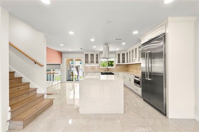 241 S Solomon Dr, Anaheim, CA 92807 - kitchen with stainless steel appliances, island range hood, light countertops, a kitchen island, and a sink