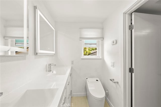 241 S Solomon Dr, Anaheim, CA 92807 - bathroom featuring double vanity, baseboards, tile patterned floors, and toilet
